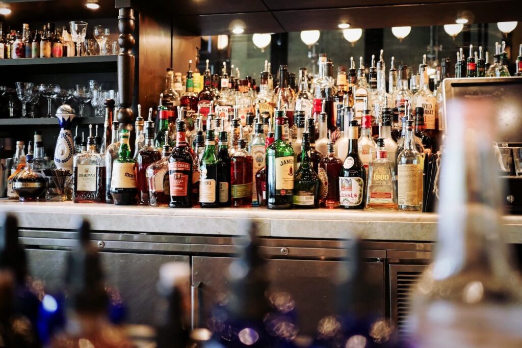 Bottles and glassware behind the bar at a Berlin cocktail venue.