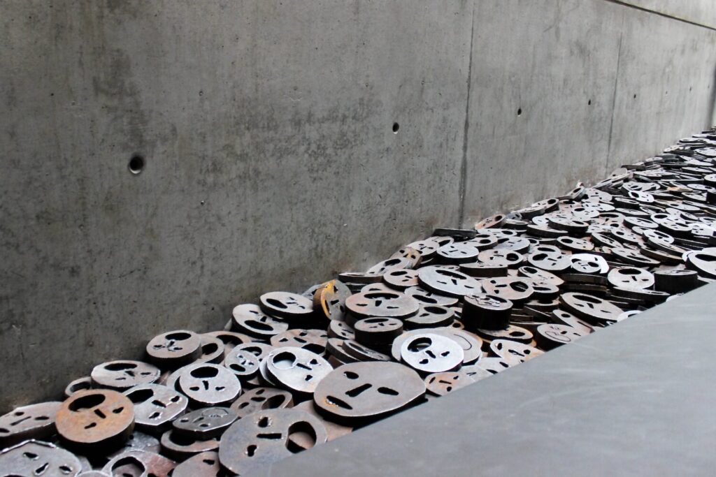 Shalekhet installation in the Memory Void at the Jewish Museum Berlin, with metal faces symbolizing memory and loss.