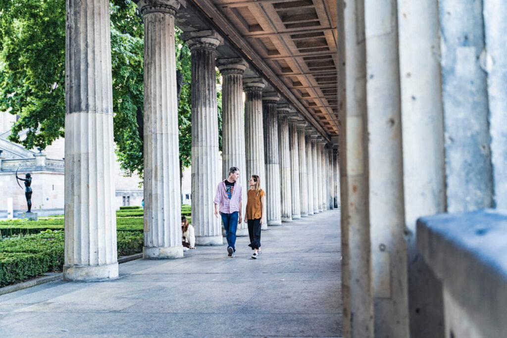 Travelers walking through the historic colonnade on Berlin’s Museum Island.