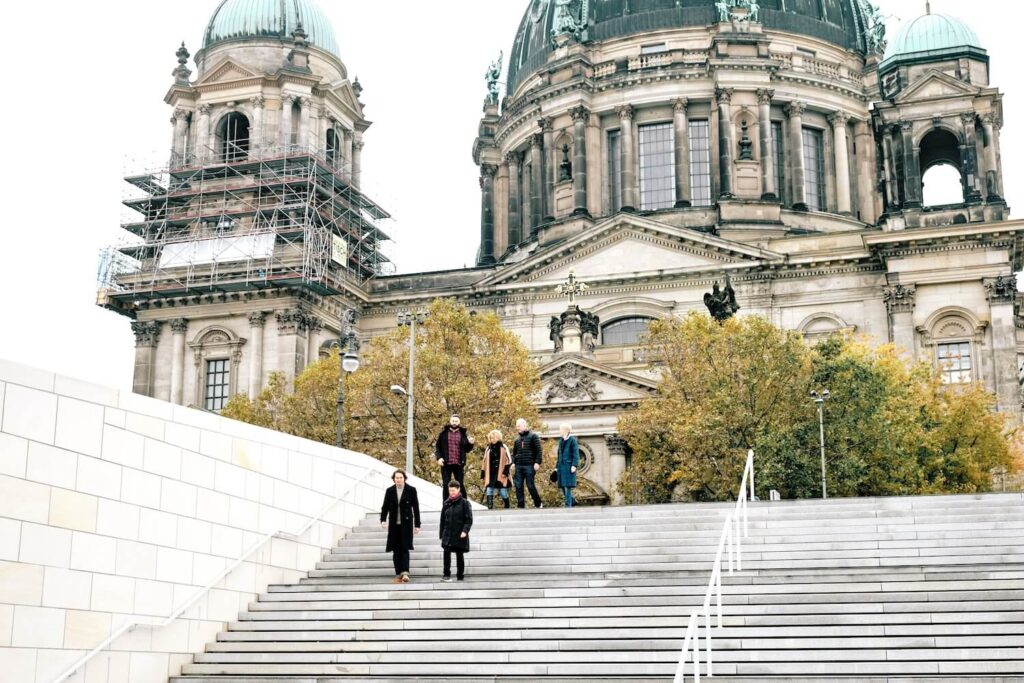 Private guide and travelers walking near Berlin Cathedral during a customized Berlin city tour.