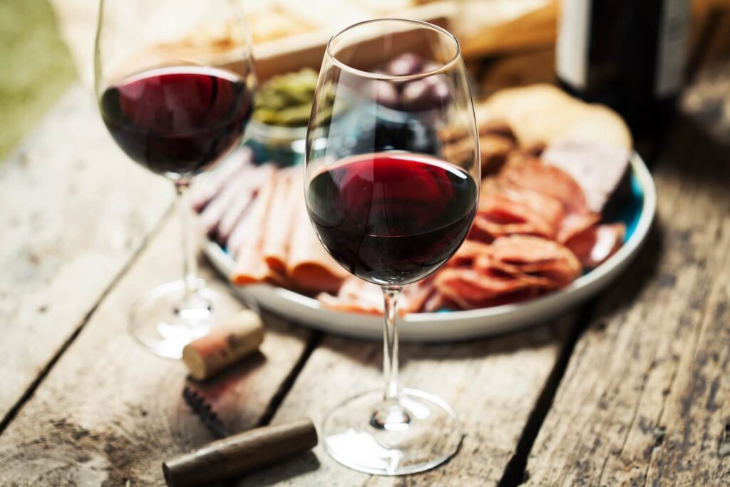 Glasses of red wine with charcuterie and snacks during a private Berlin food experience.