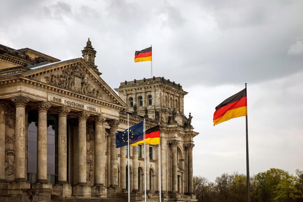 Reichstag building with German and European flags, a key landmark on a Berlin city highlights tour.