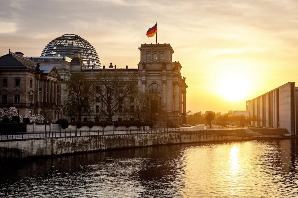 Reichstag building at sunset beside the River Spree in Berlin.