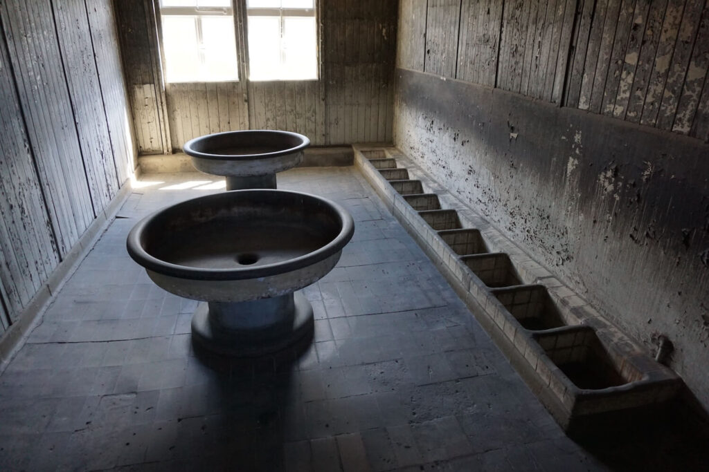 Reconstructed washroom and latrine area inside a barrack at Sachsenhausen Concentration Camp Memorial.