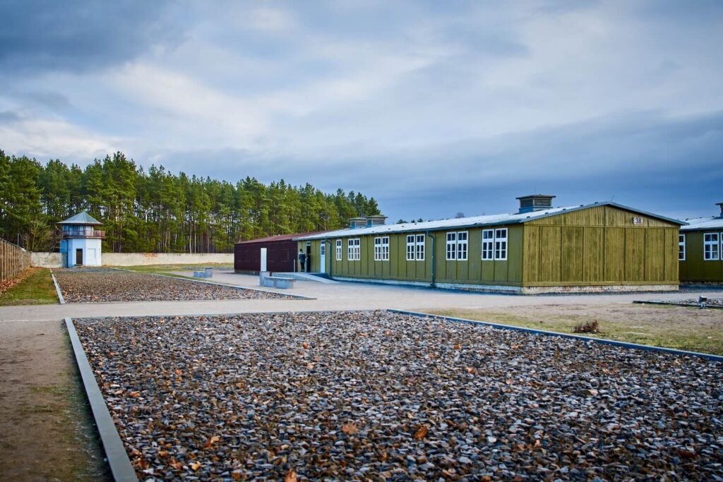 Reconstructed barracks and watchtower at Sachsenhausen Memorial, part of the former concentration camp grounds.