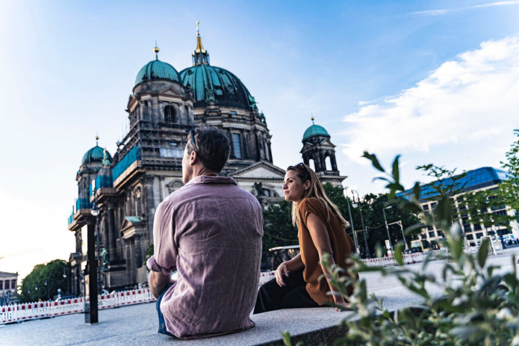Travelers sitting near Berlin Cathedral on Museum Island during a private Berlin history tour.