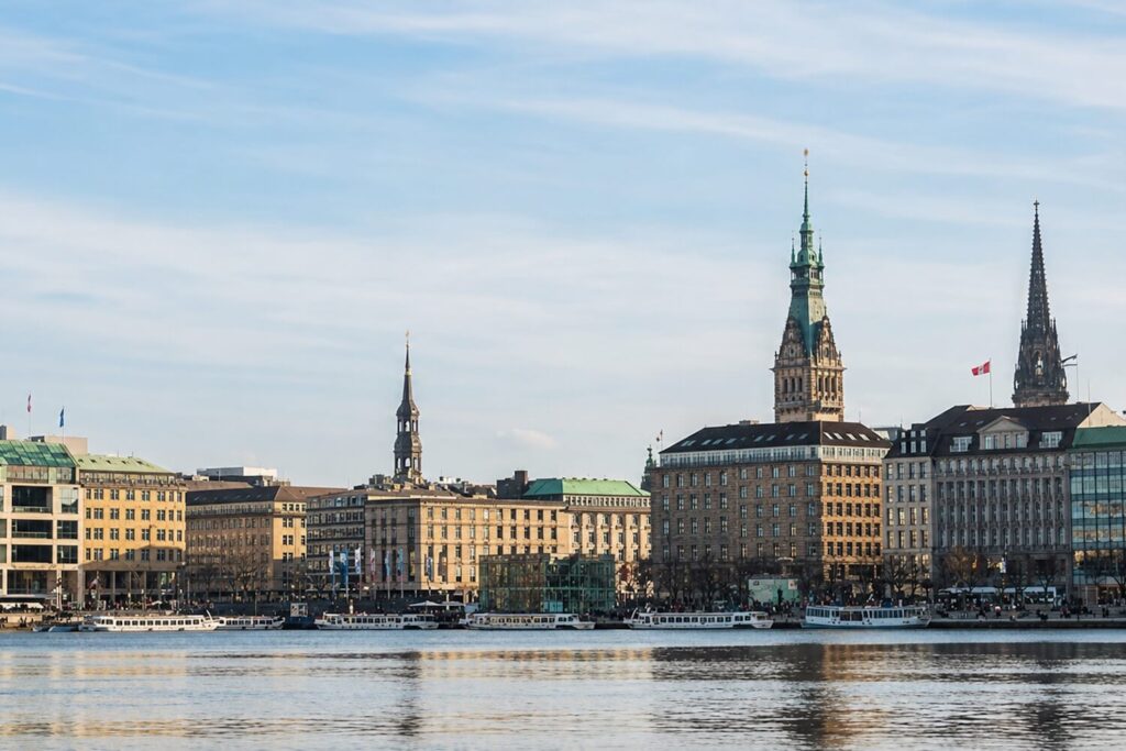 Hamburg skyline seen across the water with historic towers and waterfront buildings