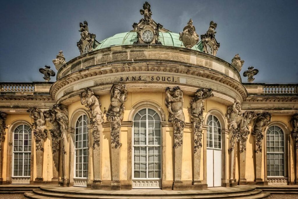 Sanssouci Palace facade in Potsdam with historic inscription and sculptures