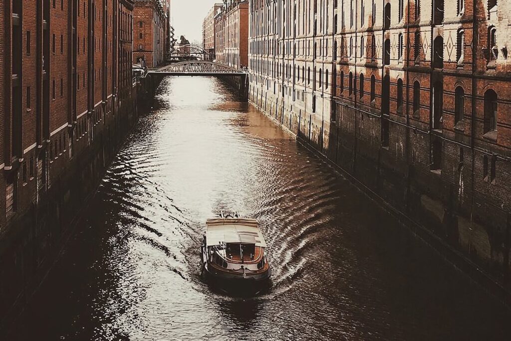 Boat passing through a canal in Hamburg’s Speicherstadt warehouse district