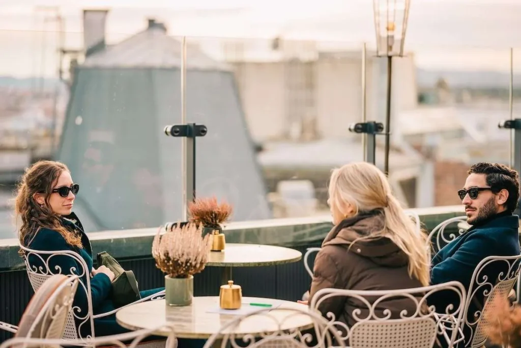 Guests relaxing on a rooftop terrace during a Vienna evening tour