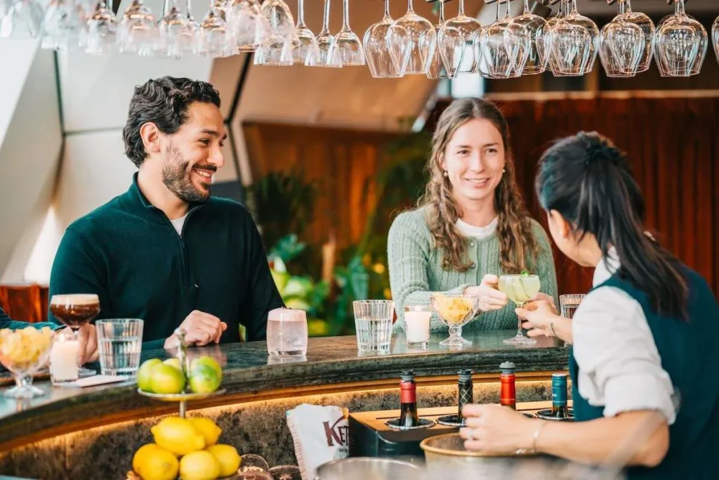 Guests enjoying cocktails at a modern Vienna bar during a nightlife tour