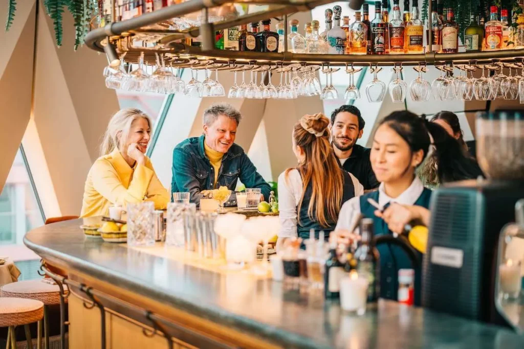 Small group enjoying drinks at a Vienna bar during an evening tour