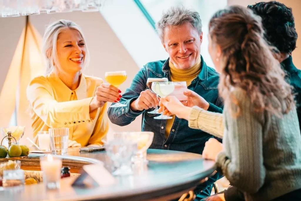 Guests toasting cocktails with a local guide on a nightlife tour